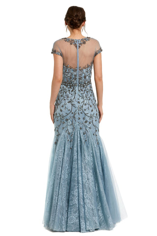 Back view of the slate blue mermaid gown showing the sheer illusion yoke and flared tulle skirt by Mac Duggal at Mrs. G