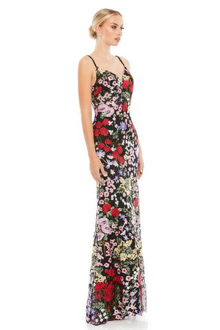 Side view of the black multi floral gown showing the fitted body and flared floral hem by Mac Duggal at Mrs. G