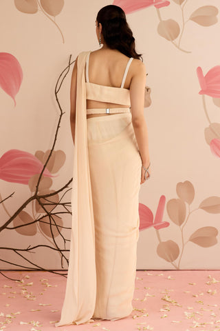 Back view of the ivory saree set showing the strappy blouse back, belt and pallu at Mrs. G