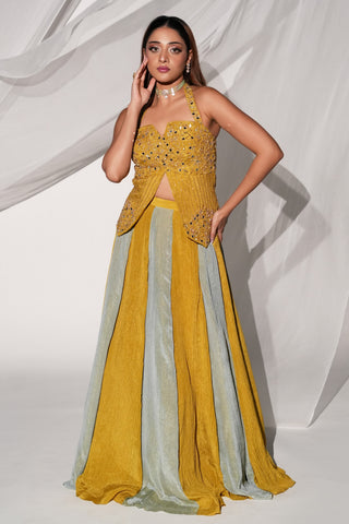 Full-length front view of the yellow mirror work halter lehenga set with paneled skirt by Kiyohra at Mrs. G