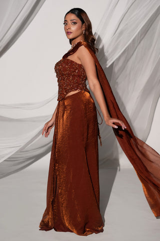 Side three-quarter view of the copper brown saree set with the drape trailing behind the skirt by Kiyohra at Mrs. G