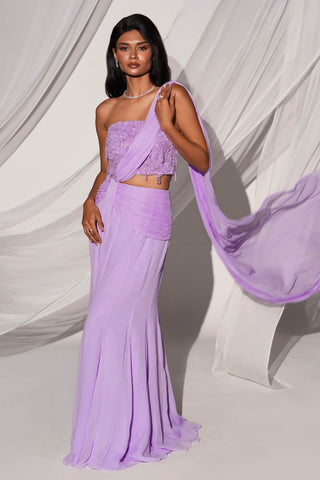 Full-length front view of the purple saree set with a beaded corset top and drape trailing behind by Kiyohra at Mrs. G