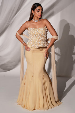 Three-quarter view of the beige lehenga set with strapless 3D floral blouse and fishtail skirt by Kiyohra at Mrs. G