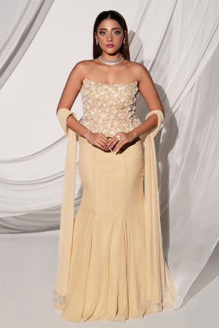 Full-length front view of the beige fishtail lehenga set with beaded tassel dupatta over both arms by Kiyohra at Mrs. G