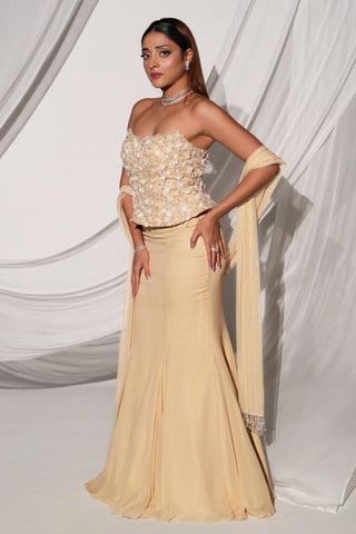 Side three-quarter view of the beige lehenga set showing the fishtail skirt line and beaded dupatta by Kiyohra at Mrs. G