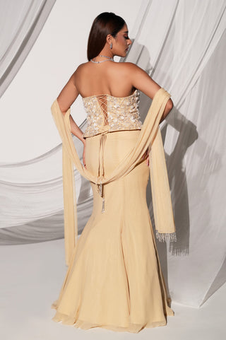 Back view of the beige lehenga set showing the lace-up blouse back, tassel cord and draped dupatta by Kiyohra at Mrs. G