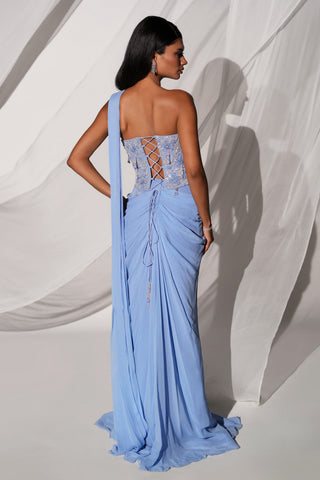 Back view of the blue corset blouse with lace-up back and tassel tie over the draped skirt by Kiyohra at Mrs. G