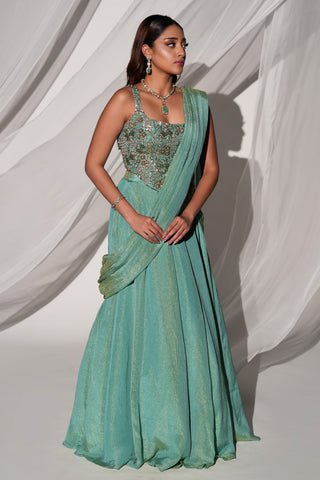 Three-quarter view of the green saree-lehenga with a square-neck embroidered blouse and drape by Kiyohra at Mrs. G