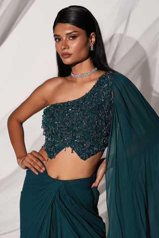 Waist-up view of the beaded one-shoulder blouse with pointed hem and veil sleeve by Kiyohra at Mrs. G