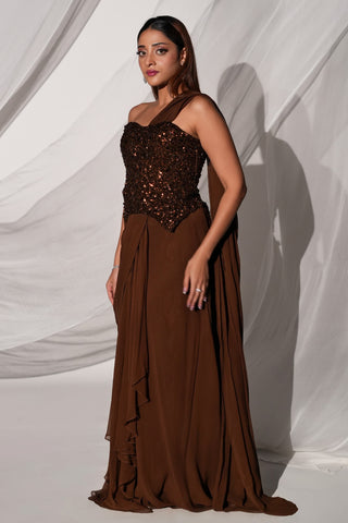 Three-quarter view of the brown saree set with the drape over one shoulder and ruffled front by Kiyohra at Mrs. G