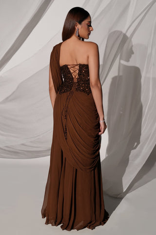 Back view of the brown corset blouse with lace-up back and tassel tie over the draped skirt by Kiyohra at Mrs. G