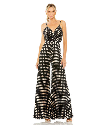 Full-length front view of the black multi polka dot jumpsuit with pleated wide legs and spaghetti straps by Mac Duggal at Mrs. G