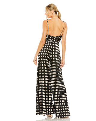 Back view of the black multi pleated jumpsuit with an open back and rows of dots down the legs by Mac Duggal at Mrs. G