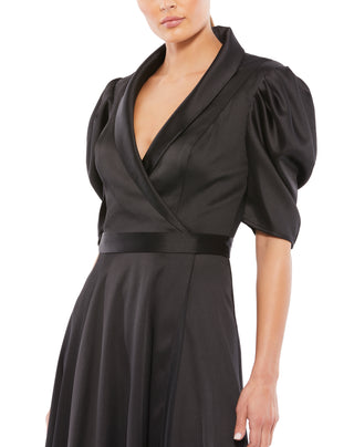 Zoomed-in close-up of the satin shawl lapel, wrap bodice, waistband and gathered puff sleeve by Mac Duggal at Mrs. G