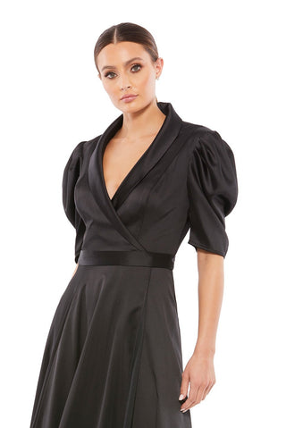 Waist-up view of the black satin lapel faux wrap puff sleeve tea length dress showing the shawl lapel and gathered puff sleeves by Mac Duggal at Mrs. G