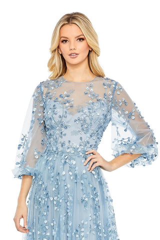 Waist-up view of the blue embroidered puff sleeve A line gown showing the leaf and vine embroidery and sheer illusion neckline by Mac Duggal at Mrs. G