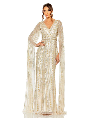 Full-length front view of the champagne silver beaded gown with long cape sleeves and a V-neckline by Mac Duggal at Mrs. G