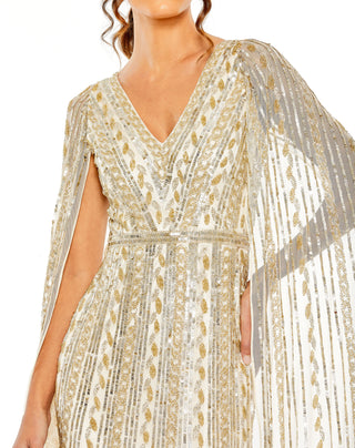 Close-up of the V-neckline, beaded waistband and sequin stripes on the champagne silver gown by Mac Duggal at Mrs. G