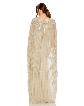 Back view of the champagne gown with the beaded cape falling to the floor by Mac Duggal at Mrs. G