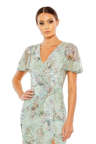Waist-up view of the seamist embellished butterfly sleeve faux wrap gown showing the wrap V-neck and sheer flutter sleeves by Mac Duggal at Mrs. G