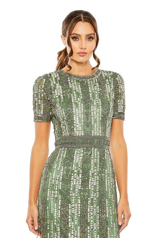Waist-up view of the sage short sleeve high neck beaded fringe midi dress showing the short sleeves and the beaded waistband by Mac Duggal at Mrs. G