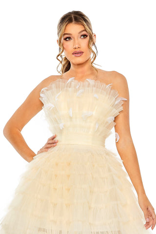 Waist-up view of the ivory feathered strapless tulle short dress showing the ruffled tulle bustier with white feather accents by Mac Duggal at Mrs. G