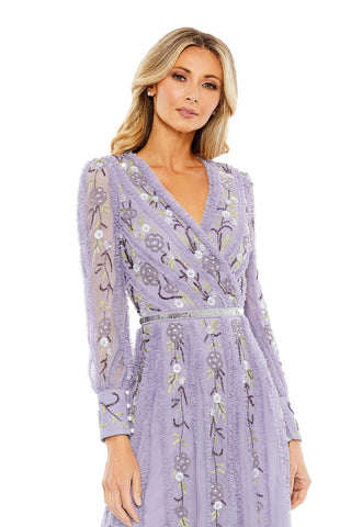 Waist-up view of the lilac floral embroidered ruffle trim long sleeve wrap midi dress showing the crossover V-neckline and embroidered flowers on the sleeves by Mac Duggal at Mrs. G