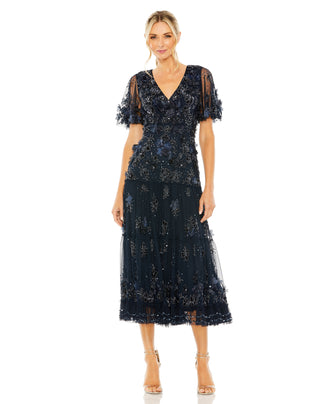 Full-length front view of the midnight beaded midi dress with 3D flowers and a tiered skirt by Mac Duggal at Mrs. G