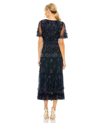 Back view of the midnight tiered midi dress with a closed back and micro-ruffle hem by Mac Duggal at Mrs. G