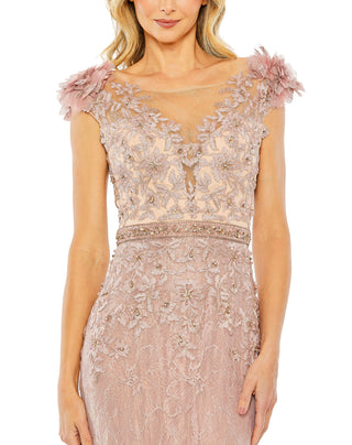 Close-up of the illusion boat neckline, 3D flower shoulders and rhinestone waistband on the mocha gown by Mac Duggal at Mrs. G