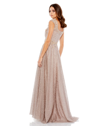 Back three-quarter view of the mocha gown showing the square back neckline and sweeping A-line skirt by Mac Duggal at Mrs. G