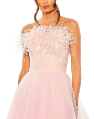 Zoomed-in close-up of the feather trimmed strapless neckline and ruched bodice on the pink ombre gown by Mac Duggal at Mrs. G