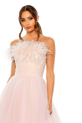 Waist-up view of the pink ombre strapless feather bodice tulle ball gown showing the feather trimmed strapless neckline by Mac Duggal at Mrs. G