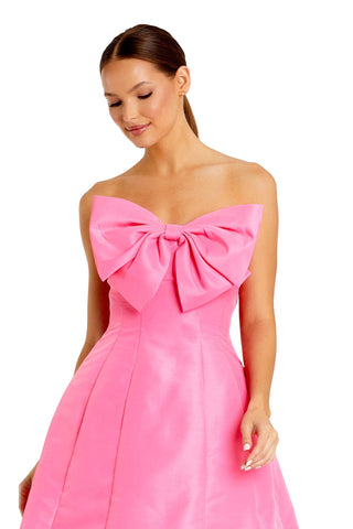 Waist-up view of the pink strapless oversized bow mini dress showing the oversized bow at the strapless neckline by Mac Duggal at Mrs. G