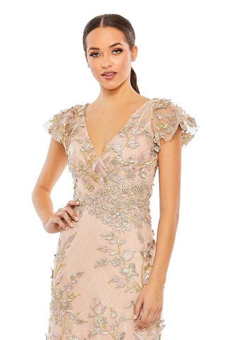 Waist-up view of the rose gold applique wrap over flutter sleeve gown showing the V neckline, flutter sleeves and gold leaf appliques by Mac Duggal at Mrs. G