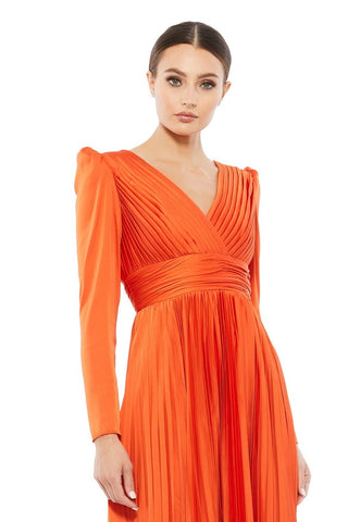 Waist-up view of the sunset pleated long sleeve V neck gown showing the pleated wrap bodice and puffed shoulders by Mac Duggal at Mrs. G