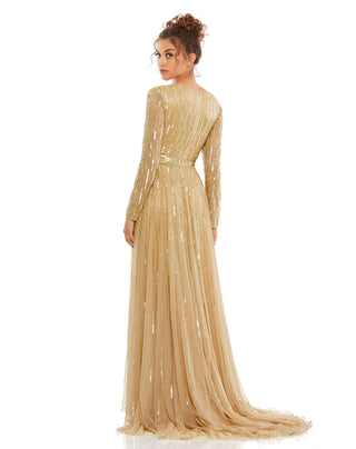 Back three-quarter view of the taupe sequined A-line gown with its sweeping train by Mac Duggal at Mrs. G