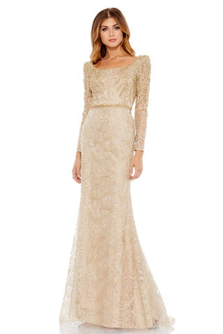 Full-length front view of the light gold long-sleeve mermaid gown with scoop neck and leaf appliques by Mac Duggal at Mrs. G