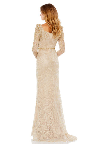 Back view of the light gold mermaid gown showing the sheer leaf-appliqued sleeves and gentle sweep by Mac Duggal at Mrs. G