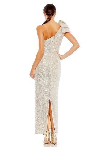 Back view of the silver sequin gown showing the shoulder bow, gathered back neckline and slit by Mac Duggal at Mrs. G