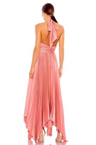 Back view of the pink pleated gown showing the open back, neck bow and handkerchief hem by Mac Duggal at Mrs. G