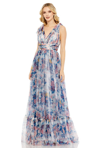 Three-quarter front view of the blue floral gown with V-neck, tie shoulders and tiered hem by Mac Duggal at Mrs. G