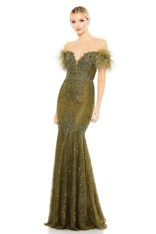 Three-quarter front view of the olive green off-shoulder trumpet gown with feathered sleeves by Mac Duggal at Mrs. G