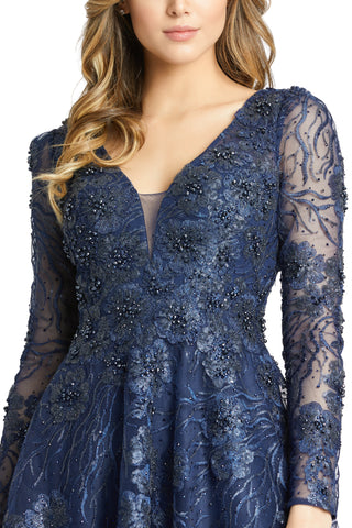 Zoomed-in close-up of the illusion plunge neckline, beaded flowers and vine-embroidered sleeves by Mac Duggal at Mrs. G