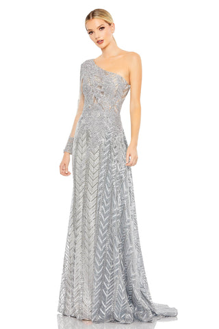 Full-length three-quarter view of the platinum silver one-shoulder gown with a sheer sleeve and chevron skirt by Mac Duggal at Mrs. G