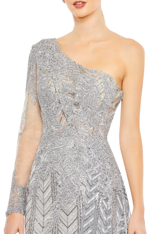 Waist-up close-up of the beaded bodice appliqué and beaded sleeve cuff on the platinum gown by Mac Duggal at Mrs. G