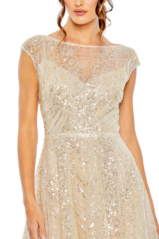 Close-up of the high illusion neckline, sheer cap sleeve and sequin bodice by Mac Duggal at Mrs. G