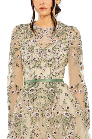 Close-up of the beaded high neckline, sheer sleeve and sage satin belt on the floral gown by Mac Duggal at Mrs. G