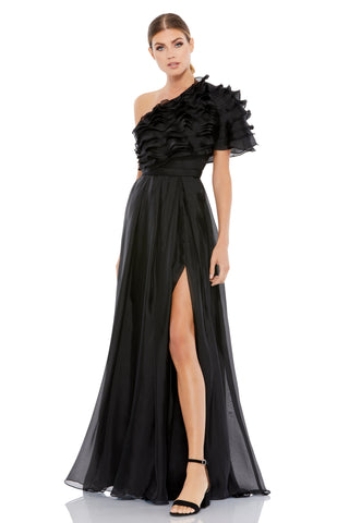 Three-quarter front view of the black one-shoulder gown with tiered ruffles and a high slit by Mac Duggal at Mrs. G