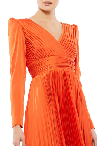 Zoomed-in close-up of the pleated wrap bodice, ruched waistband and puffed shoulder by Mac Duggal at Mrs. G